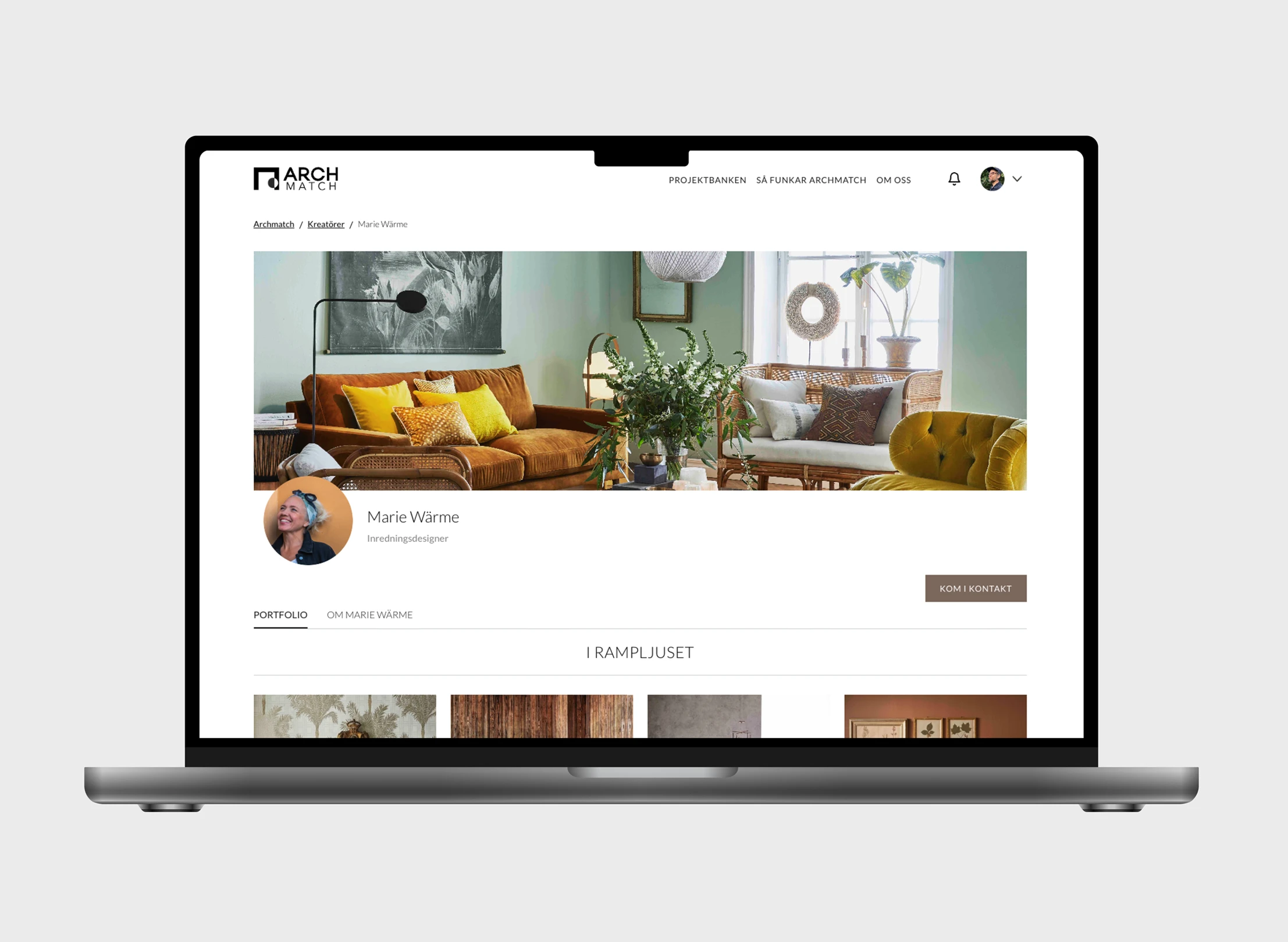 Laptop screen showing interior designer Marie Wärme's profile on Arch Match website with living room photo and contact button.